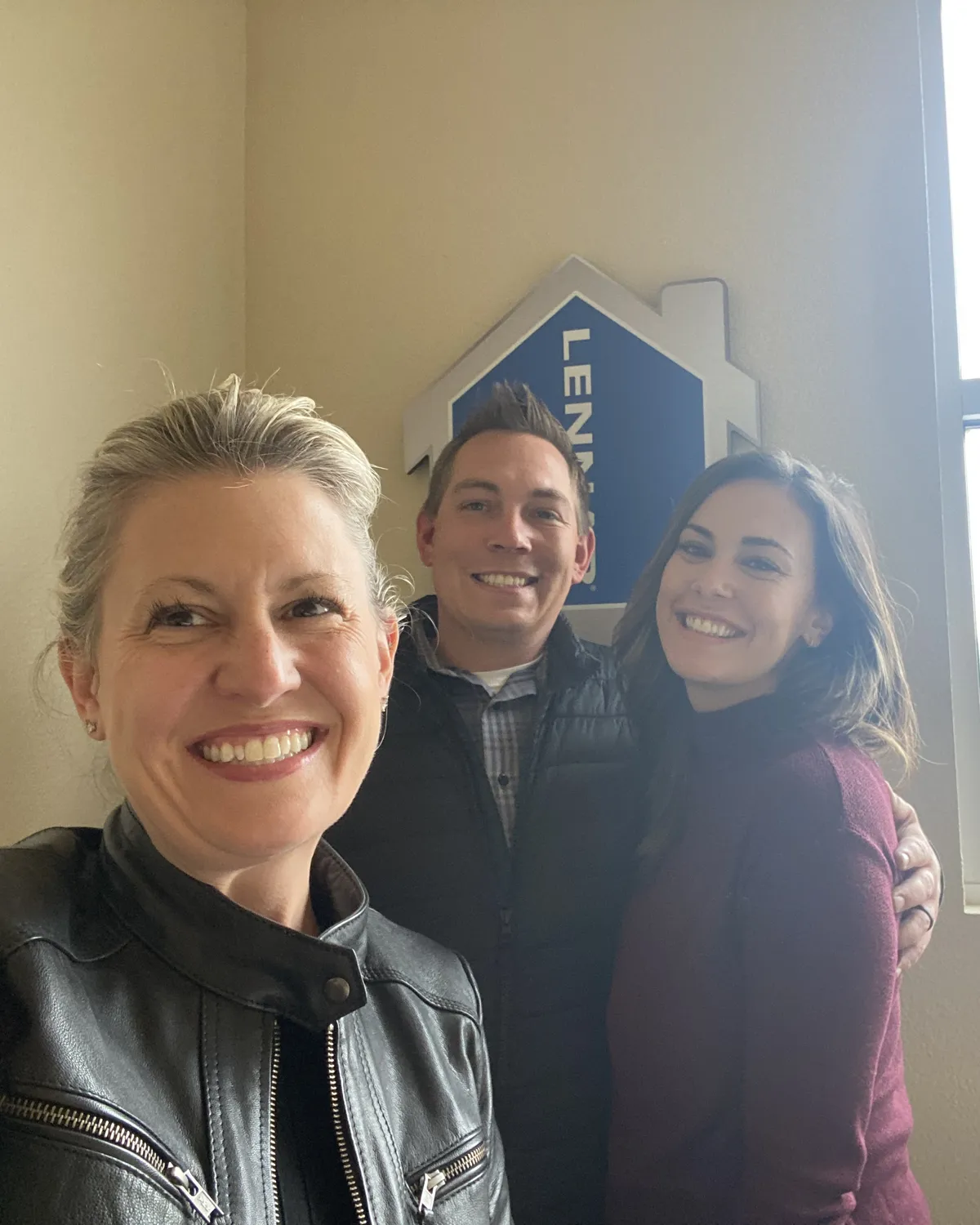 Brandy Unruh, REALTOR® with Compass, taking a selfie with new homeowners in Colorado
